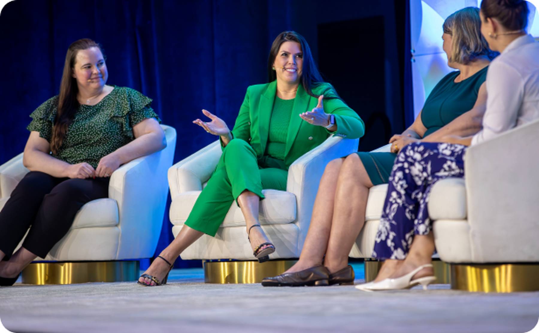 Female entrepreneurs and professionals on stage discussing analytics topics