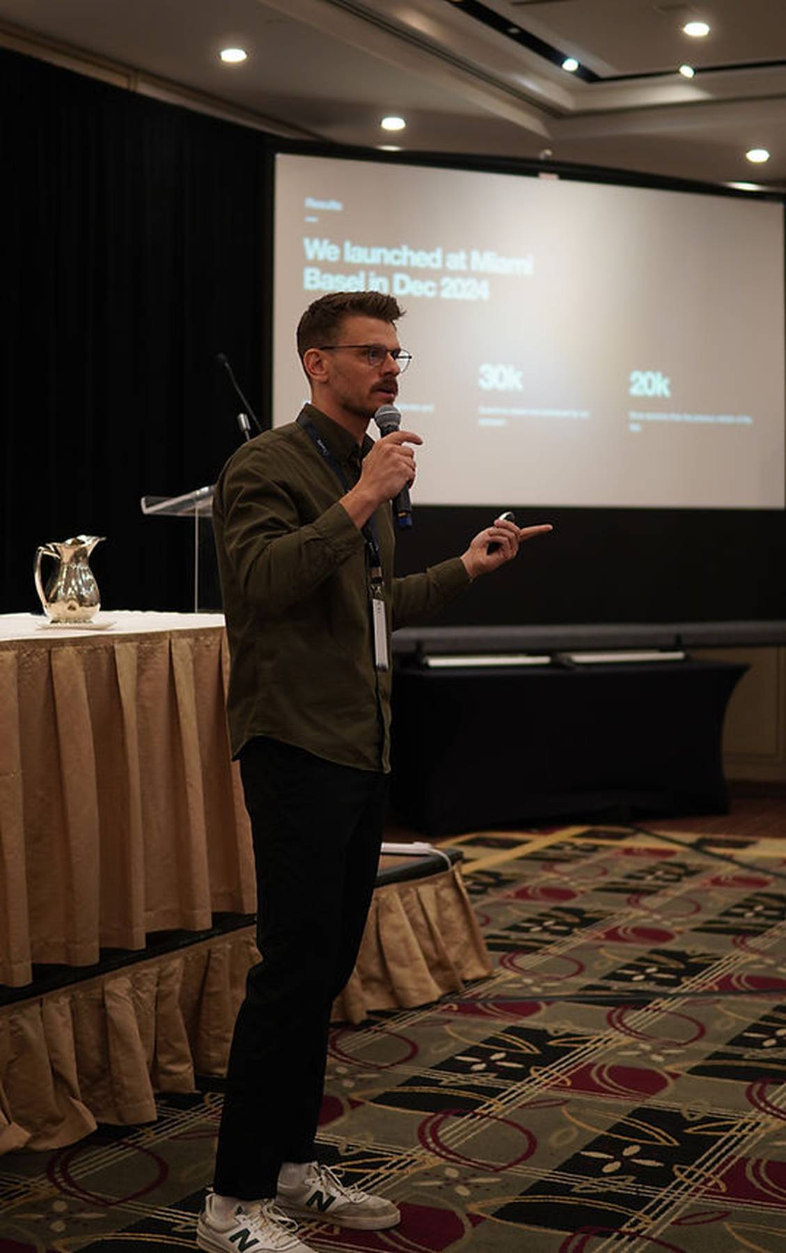 A speaker presenting at a ConfX event, illustrating the BIAAS 2026 conference